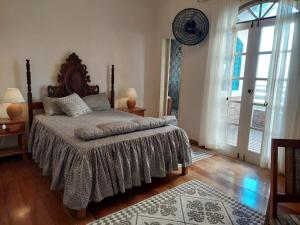 瓜拉派瑞Casa de Praia Alameda Azul的一间卧室设有一张床和一个大窗户
