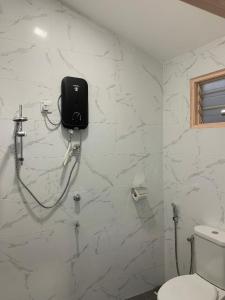 瓜埠VILLA TASIK TONGKANG KELI LANGKAWI的一间带卫生间的浴室和墙上的一部电话