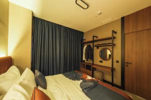 伊斯坦布尔The Kailyn Hotels&Suites Ataşehir的一间卧室配有一张床和镜子