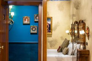威尼斯帕拉佐普瑞里酒店的一间设有蓝色墙壁、一张床和框架图片的房间