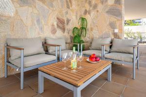 圣巴托洛梅Villa Marlenghi with Private Pool的天井上配有桌椅和酒杯
