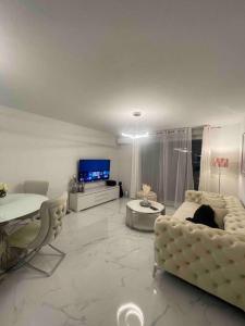 蒙彼利埃Appartement luxury的客厅配有白色家具和电视