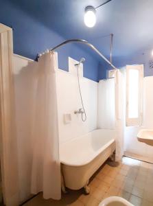 布宜诺斯艾利斯LOPEZ Hostel & Suites的带浴缸、淋浴和卫生间的浴室