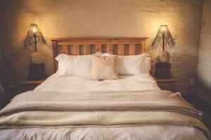 波罗瓜尼Grincourt B&B- with No Load shedding的一间卧室配有一张带两盏灯的大型白色床。