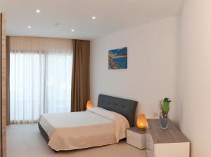 圣塔马里亚迪卡斯特天堂酒店 的白色卧室配有床和桌子