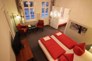 希察克尔Hotel Garni Zur Linde的一间卧室配有红色枕头的床