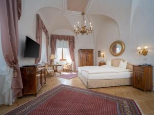杜伦斯坦施洛斯迪恩施泰因酒店的一间大卧室,配有一张床和一台电视