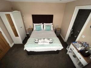 利明顿Highfield Coach House的一间卧室配有一张带蓝色枕头的大床