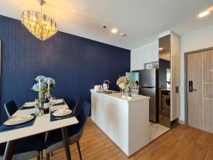清迈Sky River Luxury Perfect For 5 People的厨房以及带白色桌椅的用餐室。