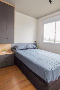圣保罗Conforto e Aconchego na Zona Sul的一间卧室设有一张大床和一个窗户。