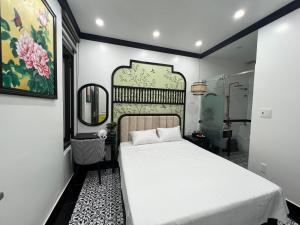 海防Song Kim Hotel的卧室配有白色的床和镜子