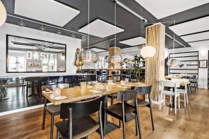 瓦埃勒Best Western ToRVEhallerne的用餐室配有大型木桌和椅子