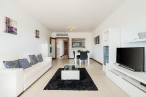 拉戈斯Marina Village Apartment的客厅配有白色沙发和电视