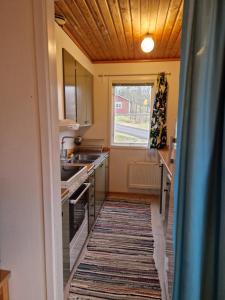UndenäsUtsikt mot viken的厨房铺有地板地毯,设有窗户。