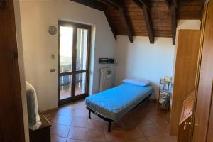 拉瓦斯克莱托Casa vacanze Ravascletto的一间卧室设有蓝色的床和窗户。