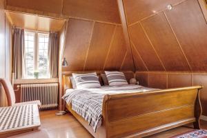 Vogelenzang德基维特度假屋的木墙客房的一张床位