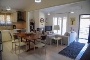 KondárainaLimnia Residence的厨房以及带桌椅的起居室。