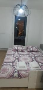 巴纽La Terrasse - big apartment & terrace 80m2 - metro 17 min from Paris的一张床位,位于一间粉色和白色毯子的房间