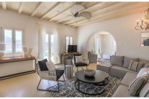 DexamenesElite Mykonos Villa - Villa Roxane - Private Pool - 6 Bedrooms - Beachfront - Ftelia的客厅配有沙发和桌子