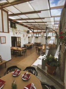 Los Molinos色彩酒店的餐厅设有桌椅和玻璃天花板