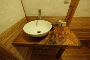 屋久岛スナッパーロック 屋久島的木桌上配有白色水槽的浴室