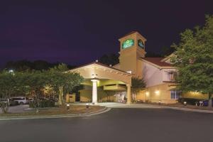 达拉姆La Quinta Inn & Suites by Wyndham University Area Chapel Hill的一座在晚上设有钟楼的大型建筑