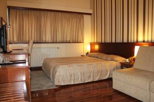 斯科普里辛塔尔酒店的酒店客房,配有床和沙发