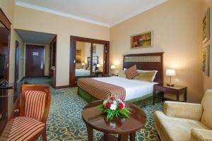 富查伊拉富查伊拉康科德酒店的酒店客房设有床和客厅。