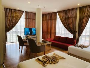 Kampong Mata Mata瓦法酒店和公寓的酒店客房,配有一张床和一张红色的沙发