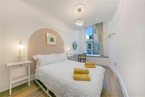 阿伯丁Market Street Apartments ✪ Grampian Lettings Ltd的卧室配有白色床和黄色毛巾
