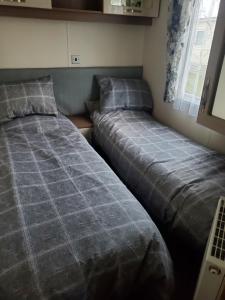 希舍姆Heysham seaview的两张睡床彼此相邻,位于一个房间里
