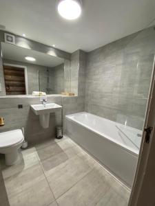 圣菲伦斯Achray House Restaurant with Rooms的带浴缸、卫生间和盥洗盆的浴室