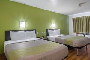 邓肯维尔达拉斯丹麦肯维尔6号汽车旅馆的绿墙客房内的两张床