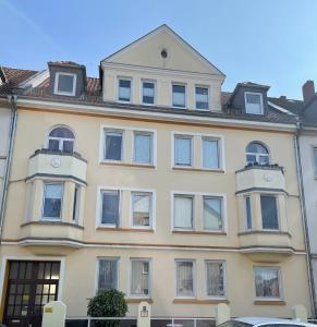汉诺威Attraktive 2 Zimmer Wohnung in Toplage, Nähe Messe的一座黄色的大建筑,上面有时钟