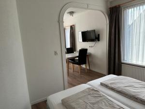 栋堡Appartementen Beatrix的酒店客房,配有床和镜子