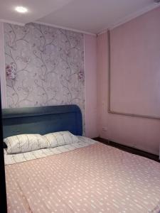 第聂伯罗2кімнатні апартаменти район Даффі的一间卧室配有一张蓝色床头板的床