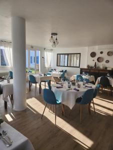 沙尼Auberge la musardière的餐厅设有白色的桌子和蓝色的椅子