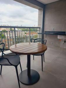圣保罗Cityhome Platina Tatuapé的带阳台的客房内的桌椅
