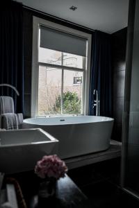 乌得勒支Anne&Max Boutique Hotel的一间带大浴缸和窗户的浴室
