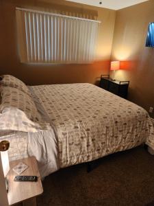 棕榈泉Palm Springs Perfect Getaway的一间卧室配有一张床和一张桌子及床头柜