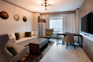 路易斯威尔路易斯维尔市中心万豪酒店 的客厅配有沙发和桌子