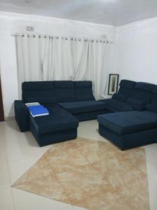卢萨卡Salama House的客厅配有蓝色的沙发和桌子