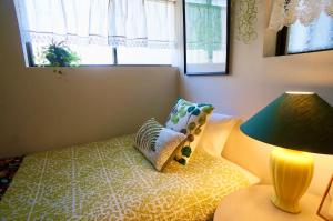 由布市阿西日式旅馆的一间卧室配有一张带枕头和灯的床