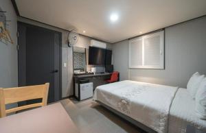 仁川市Alps Motel的一间卧室配有一张床和一张书桌