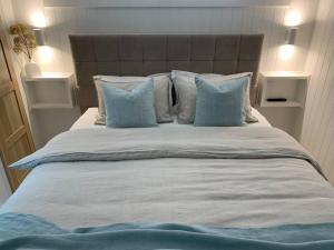 科莱特HighTide- luxury apartment, almost on the beach.的一张带蓝色枕头的大型白色床