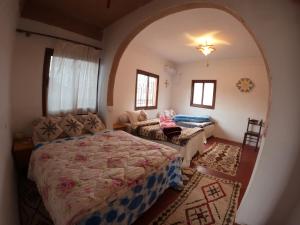 Aït Ben AliCitadelle Gorges的一间卧室配有一张床和一个沙发