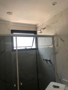 桑托斯Gonzaga Flat的带淋浴、窗户和卫生间的浴室