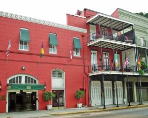 新奥尔良新奥尔良广场中心套房公寓式酒店的前面有旗帜的红色建筑