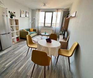 索非亚Habitat 29 Apartment的厨房以及带桌椅的起居室。