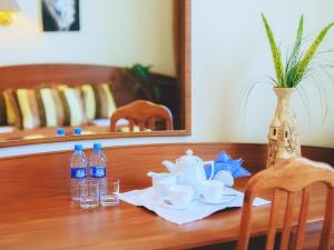 阿特劳维多利亚宫殿酒店的一张带茶具和瓶装水的木桌